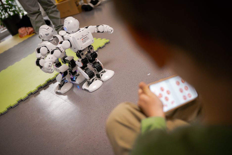 Ein Kind steuert und programmiert einen Alpha Roboter